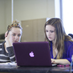 two girls on a laptop